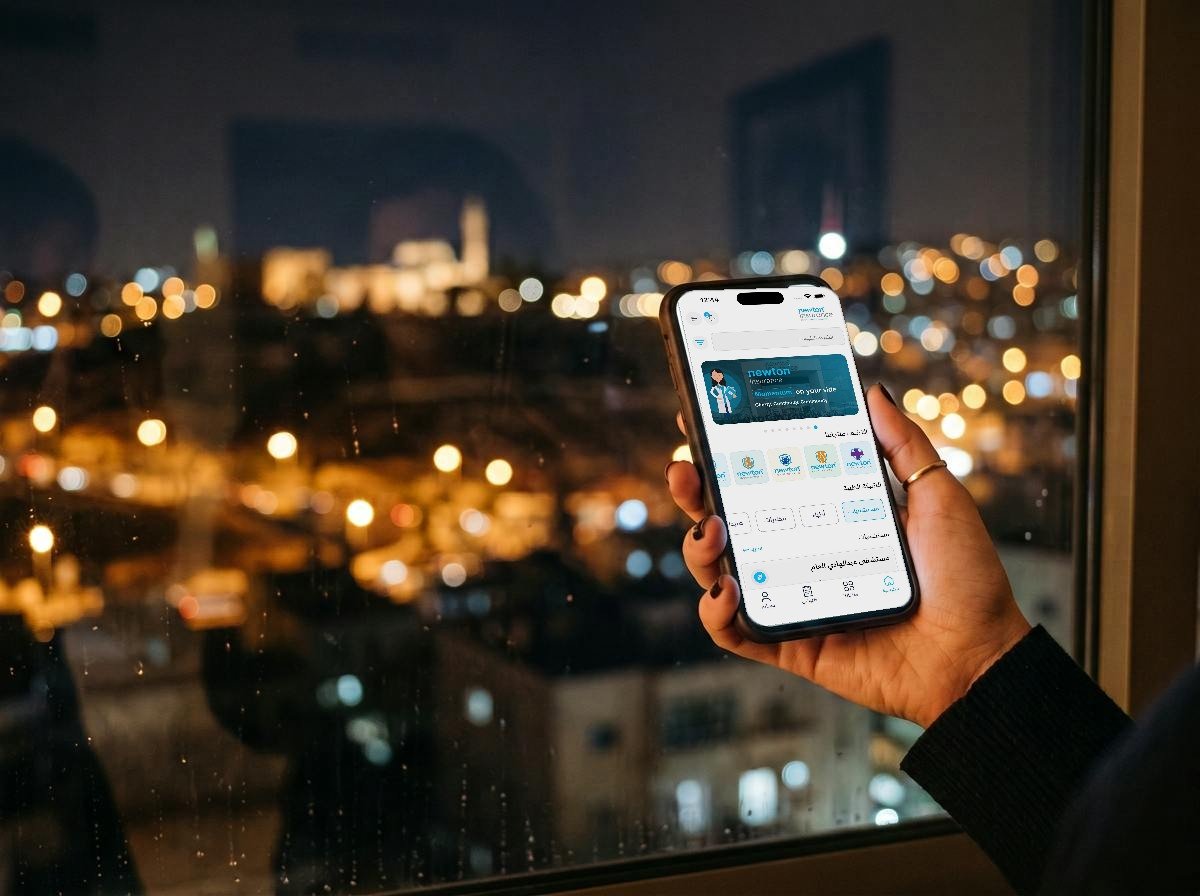 The newton insurance mobile app at night over Amman